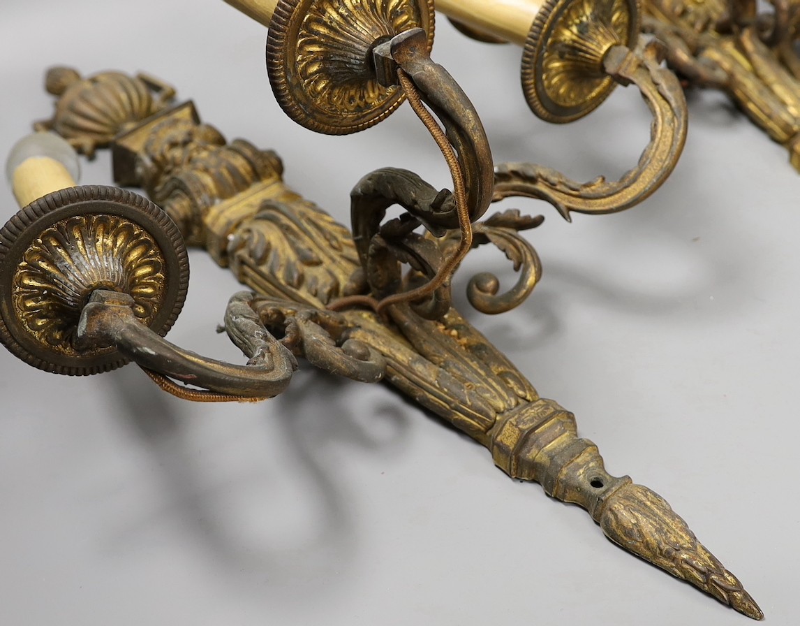 A pair of Baroque style ormolu three branch wall lights